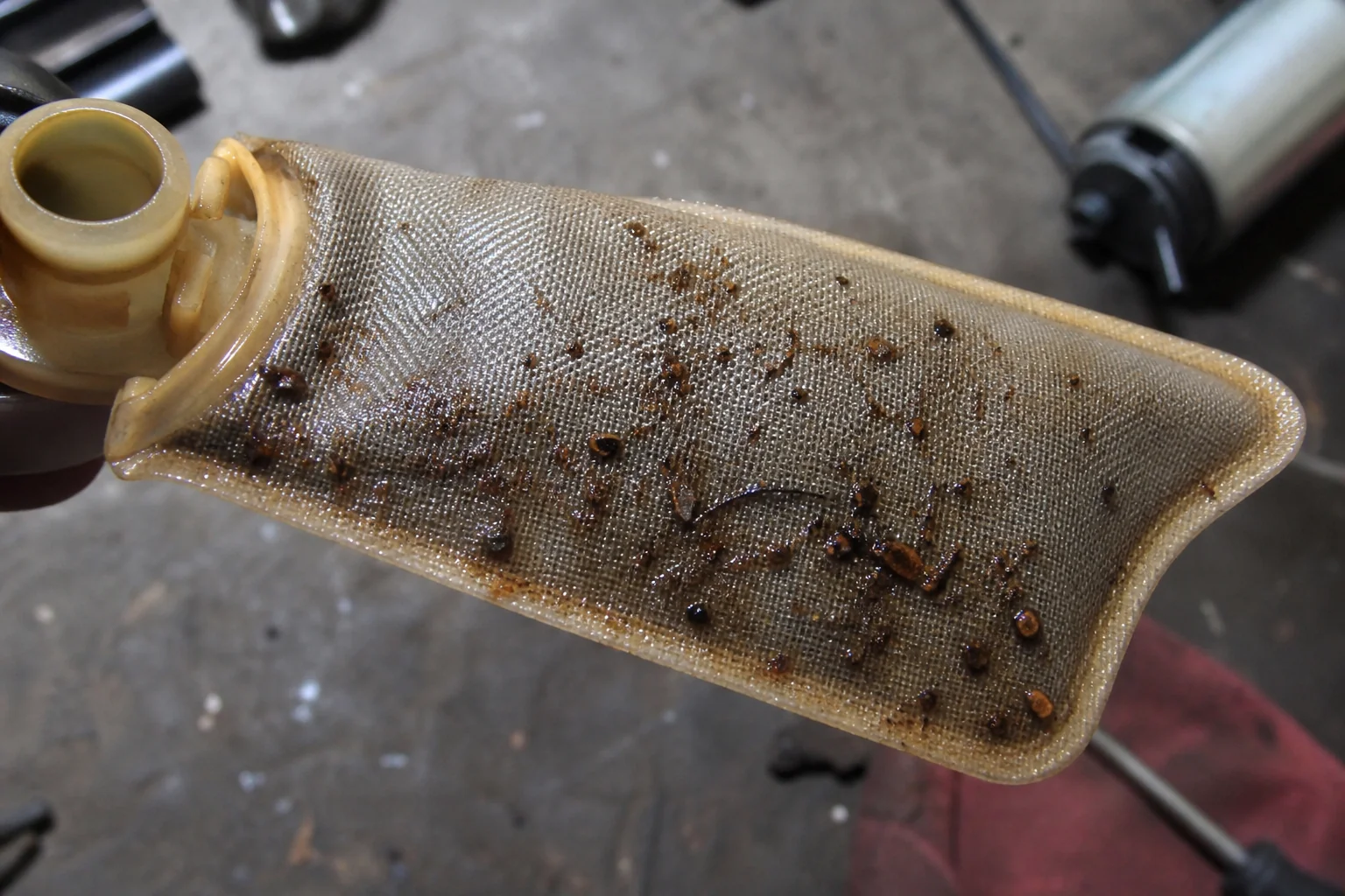 What Is the Most Common Cause of Fuel Pump Failure? Fuel pump inlet strainer clogged with rust sediment and dirt